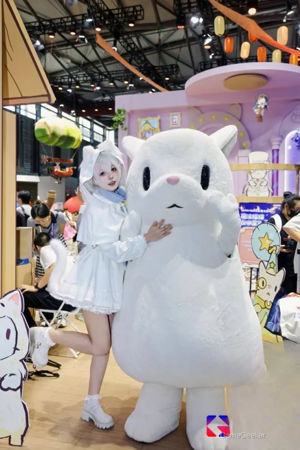 The Cat-Eared Girl and the White Cat, a charming title likely referencing an anime or game, is featured in this vibrant convention scene.