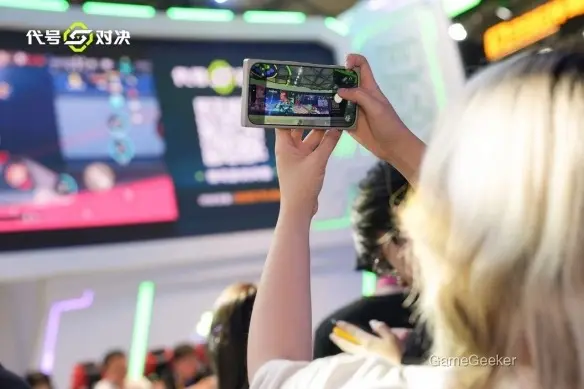 The event or game being showcased is titled "Code Name: Duel," as displayed prominently in Chinese characters on the screen and in the game interface being viewed by attendees.