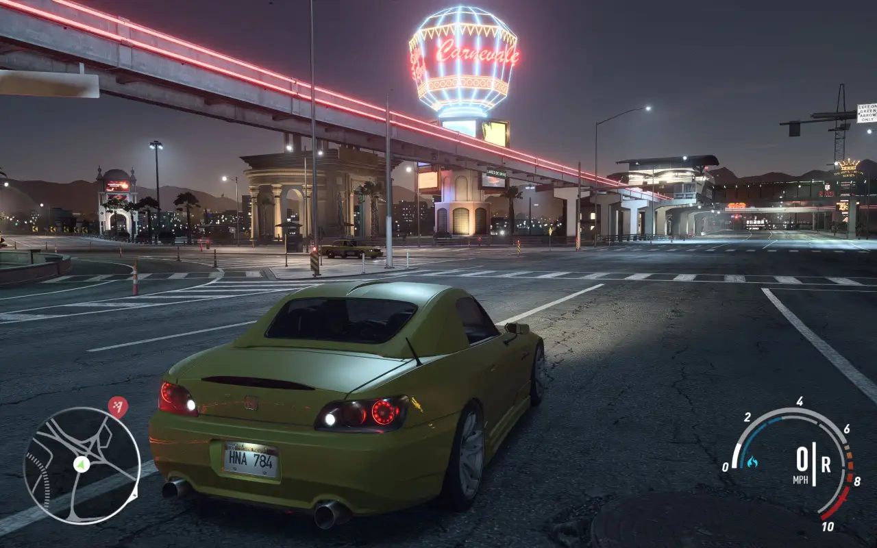 Yellow-green sports car on city street at night with casino neon lights